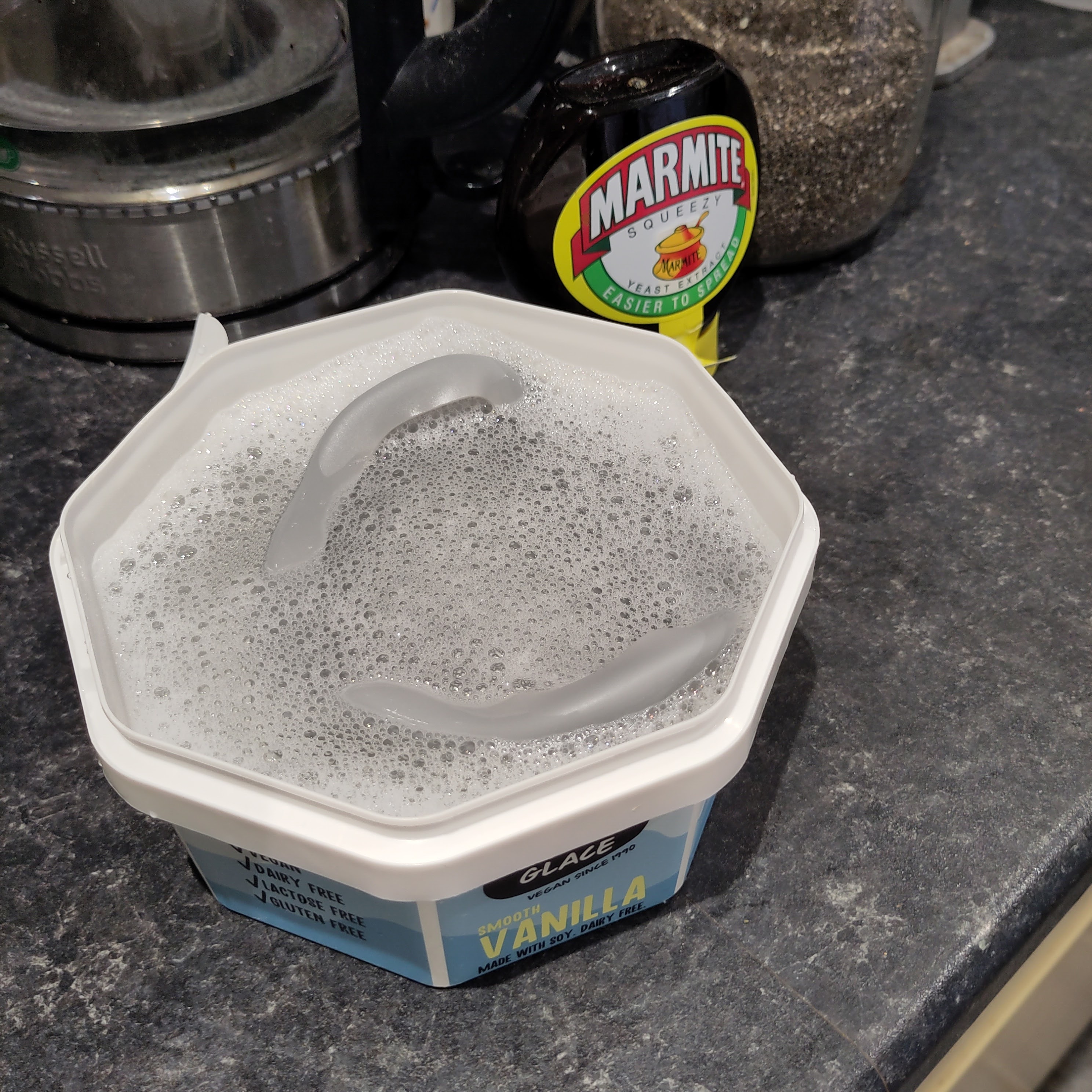 The back of the mask in a little icecream tub of soapy water