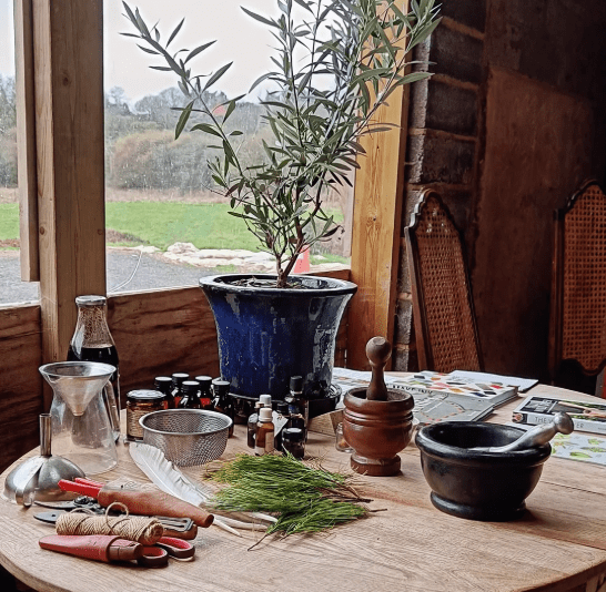 A table set up for ink making with pestles and mortars to grind pigments, a meta sieve and jars to be filled